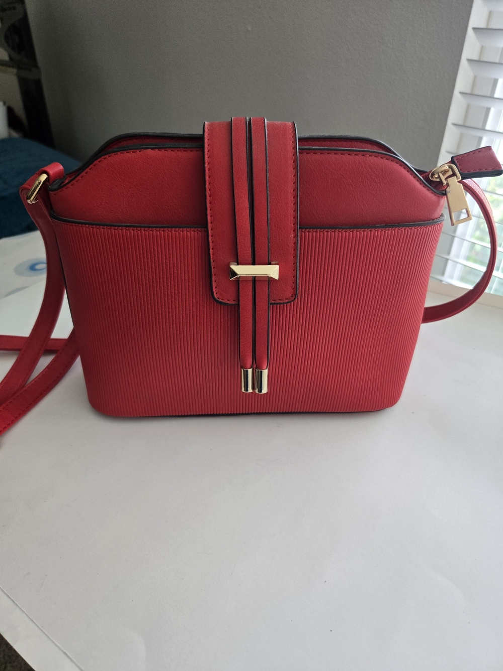 Compact Red Crossbody Bag with Gold Accent Strap